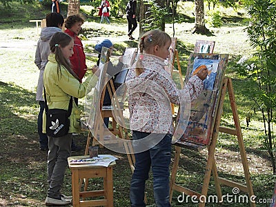 Children drawing on easels outdoor Editorial Stock Photo