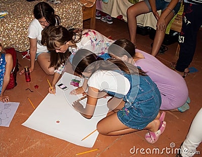 Children drawing a painting on the paper Editorial Stock Photo