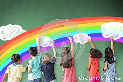 Children drawing rainbow and cloud on the chalkboard Stock Photo