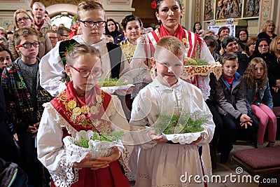 Children dressed in traditional folk costumes in the church at the Mass on Thanksgiving day in Stitar, Croatia Editorial Stock Photo