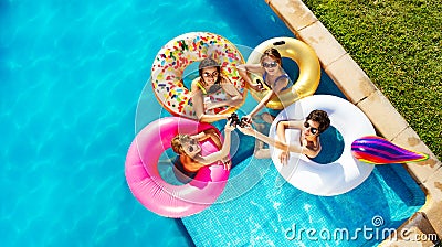 Children drink soda swim in pool on inflatable toy Stock Photo