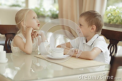 Children drink tea in cafe Stock Photo