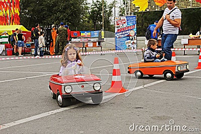 Children driving Soviet pedal cars `Moskvich` at the City Day in Volgograd Editorial Stock Photo
