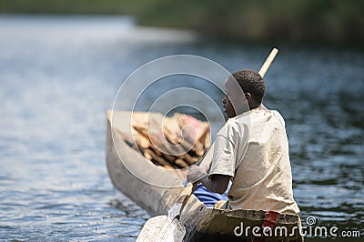 Children in a dugout canoe on Lake Bunyonyi Editorial Stock Photo