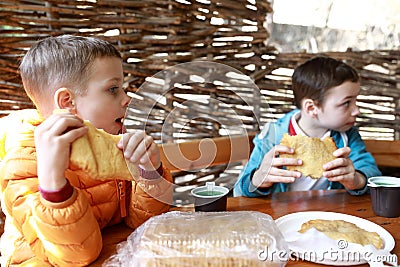 Children eating Khychin in restaurant Stock Photo