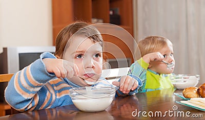 Children eating yogurt Stock Photo