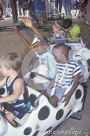 Children enjoying a carnival ride Editorial Stock Photo