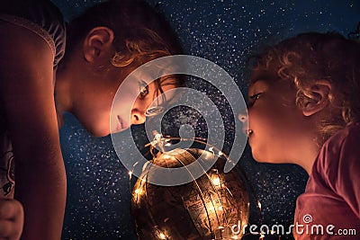 Children exploring night sky with space stars and earth planet concept astronomy and discovery Stock Photo