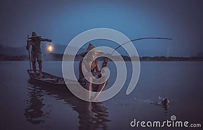 Children Fisherman with father catching fish on lake river Stock Photo