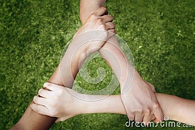 Children forming triangle by holding arms Stock Photo