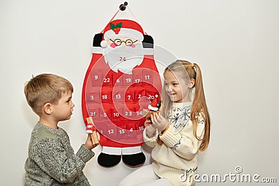 Children found gifts in Felt santa claus advent calendar Stock Photo