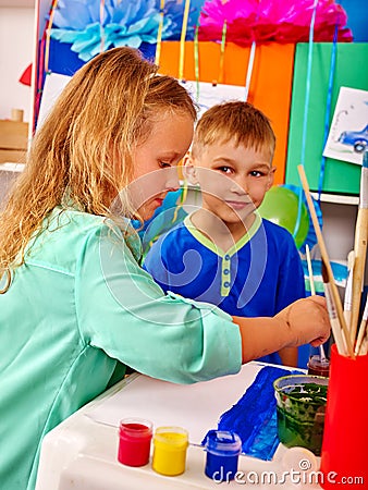 Children girl and boy with brush painting in primary school. Stock Photo