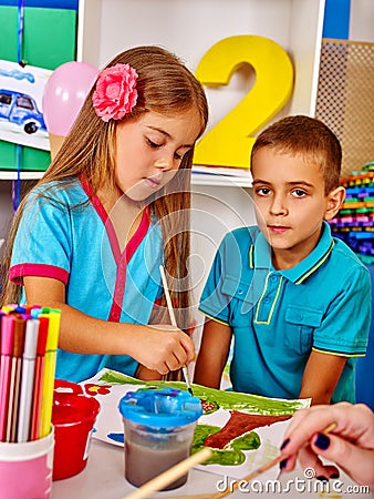 Children girl and boy with brush painting in primary school. Stock Photo