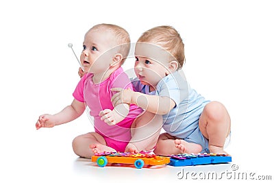 Children girl and boy play musical toys Stock Photo