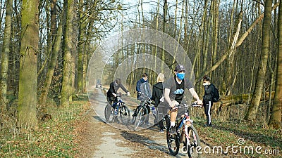 OLOMOUC, CZECH REPUBLIC, MARCH 19, 2020: Children girls boys group on trip bikes wood nature violate Government law Czech Republic Editorial Stock Photo