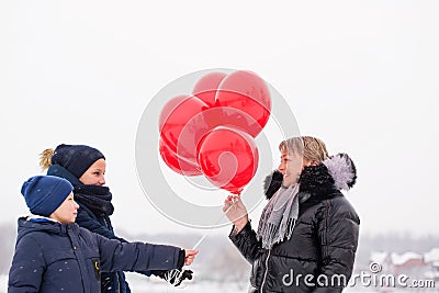 Children give mom balloons Stock Photo