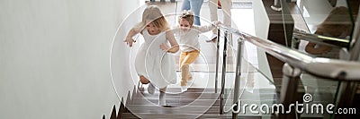 Children going upstairs to second floor their new modern house Stock Photo