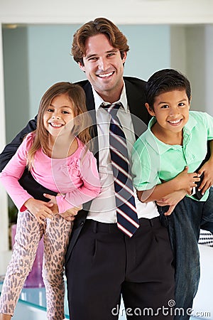 Children Greeting Father On Return From Work Stock Photo