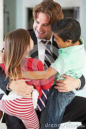 Children Greeting Father On Return From Work Stock Photo
