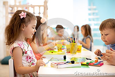 Children group learning arts and crafts in playroom with interest Stock Photo