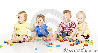 Children group playing toy blocks. Small Kids on w Stock Photo