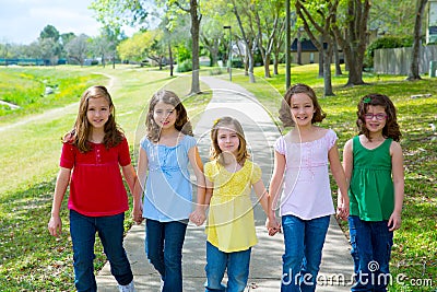 Children group of sisters girls and friends walking in park Stock Photo