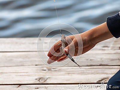 Children hand catches a small fish Stock Photo