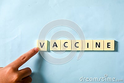 Children hand completing vaccine word on the puzzle Stock Photo