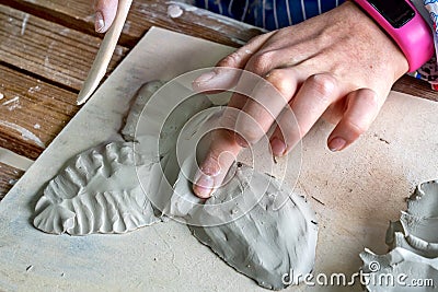 Children hand sculpts clay crafts in pottery school Stock Photo