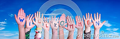 Children Hands Building Word Willkommen Means Welcome, Blue Sky Stock Photo