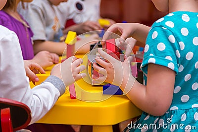 Children hands building towers out of wooden bricks Stock Photo