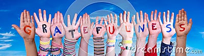 Children Hands Building Word Gratefulness, Blue Sky Stock Photo