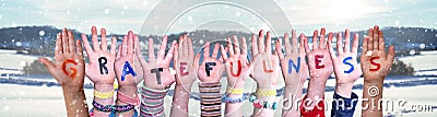 Children Hands Building Word Gratefulness, Snowy Winter Background Stock Photo