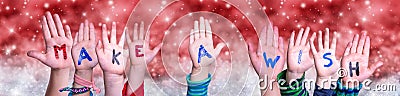 Children Hands Building Word Make A Wish, Red Christmas Background Stock Photo