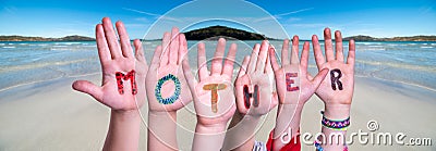 Children Hands Building Word Mother, Ocean Background Stock Photo