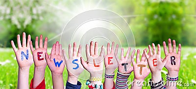 Children Hands Building Word Newsletter, Grass Meadow Stock Photo