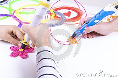 Kids hands creating new 3d object with 3d pen. Learning and entertainment at home Stock Photo