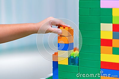 Children hands play with colorful plastic toys blocks on table Stock Photo