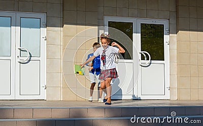 Children happily run from school after the end of lessons Stock Photo