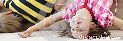 Children have fun at home, kids upside down on sofa, holiday at school Stock Photo