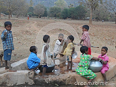 A Children have gathered in the hand pump for water Editorial Stock Photo