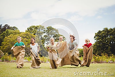 Children having a sack race in park Stock Photo