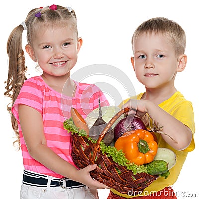 Children hold a basket with vegetables Stock Photo