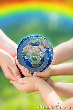 Children holding Earth in hands Stock Photo