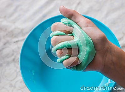 Children holding green slime in their hand. Stock Photo