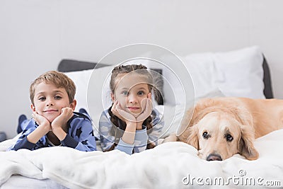 Preschooler children lying on a bed Stock Photo