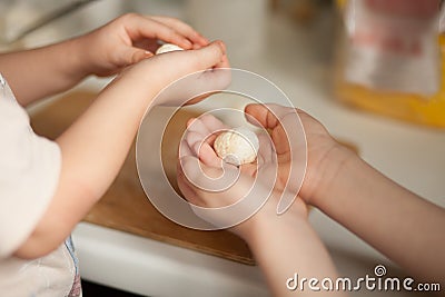 Children making a cottage cheese balls Russian syrniki in the home kitchen Stock Photo