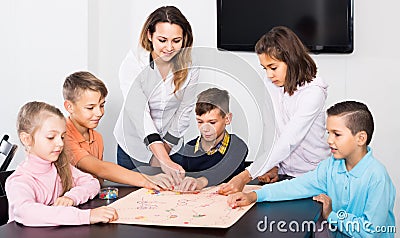 Children making move on pre-marked surface of board game Stock Photo