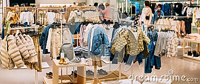 Children Male Man Casual Clothes And Children Clothes On Shelves And Hanger In Store Of Shopping Center. Stack Of Editorial Stock Photo