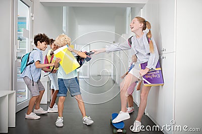 Children offending and bullying boy near lockers Stock Photo